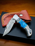 Blue Ridge Damascus Pocket Knife in a custom leather case, offering stylish protection and easy transport