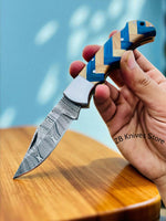 Close-up of the premium blue wood and olive wood handle of the EDC pocket knife